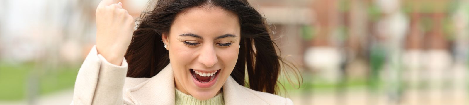 Woman smiling while raising hand